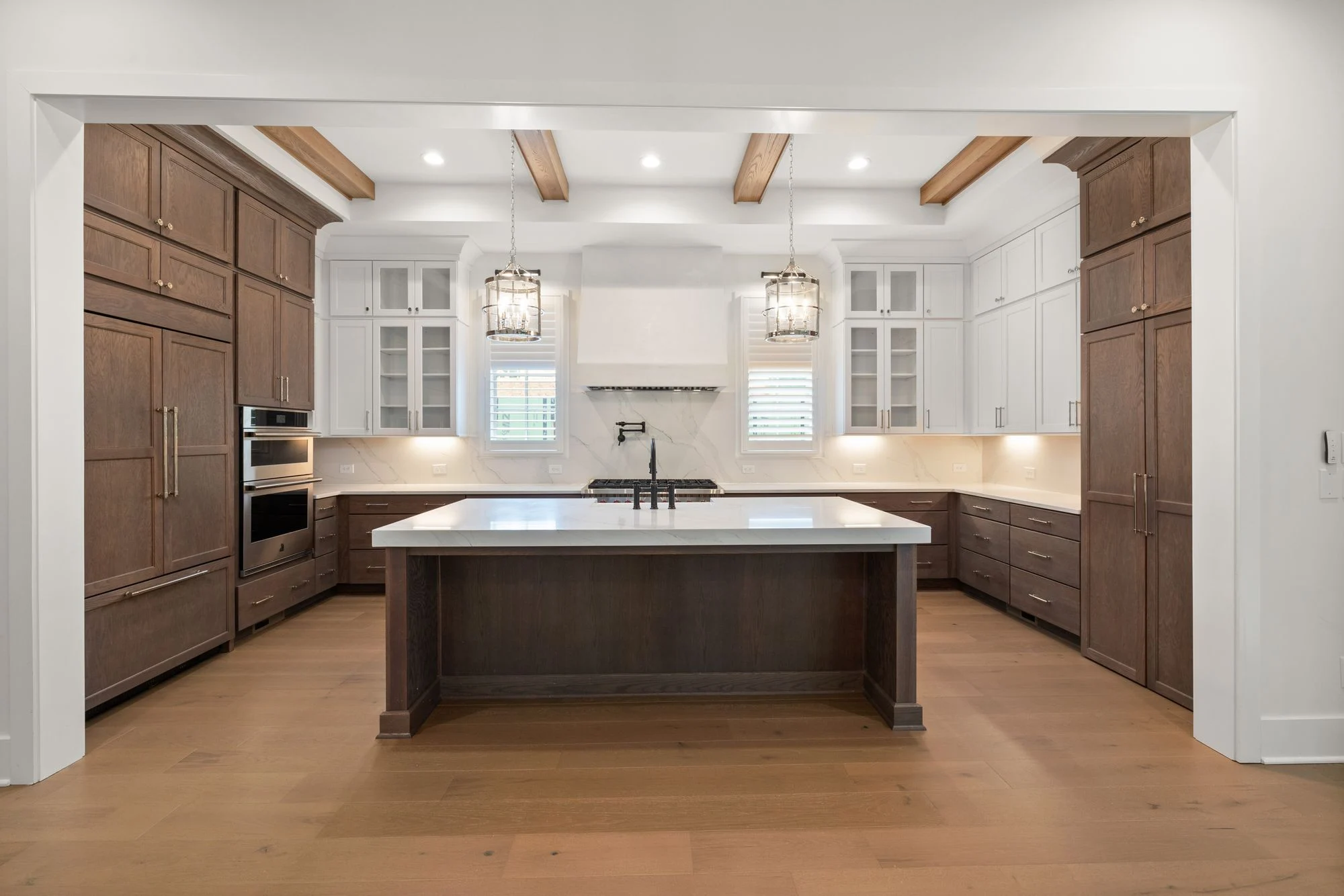 A warm wood kitchen with a central island and carefully coordinated cabinetry